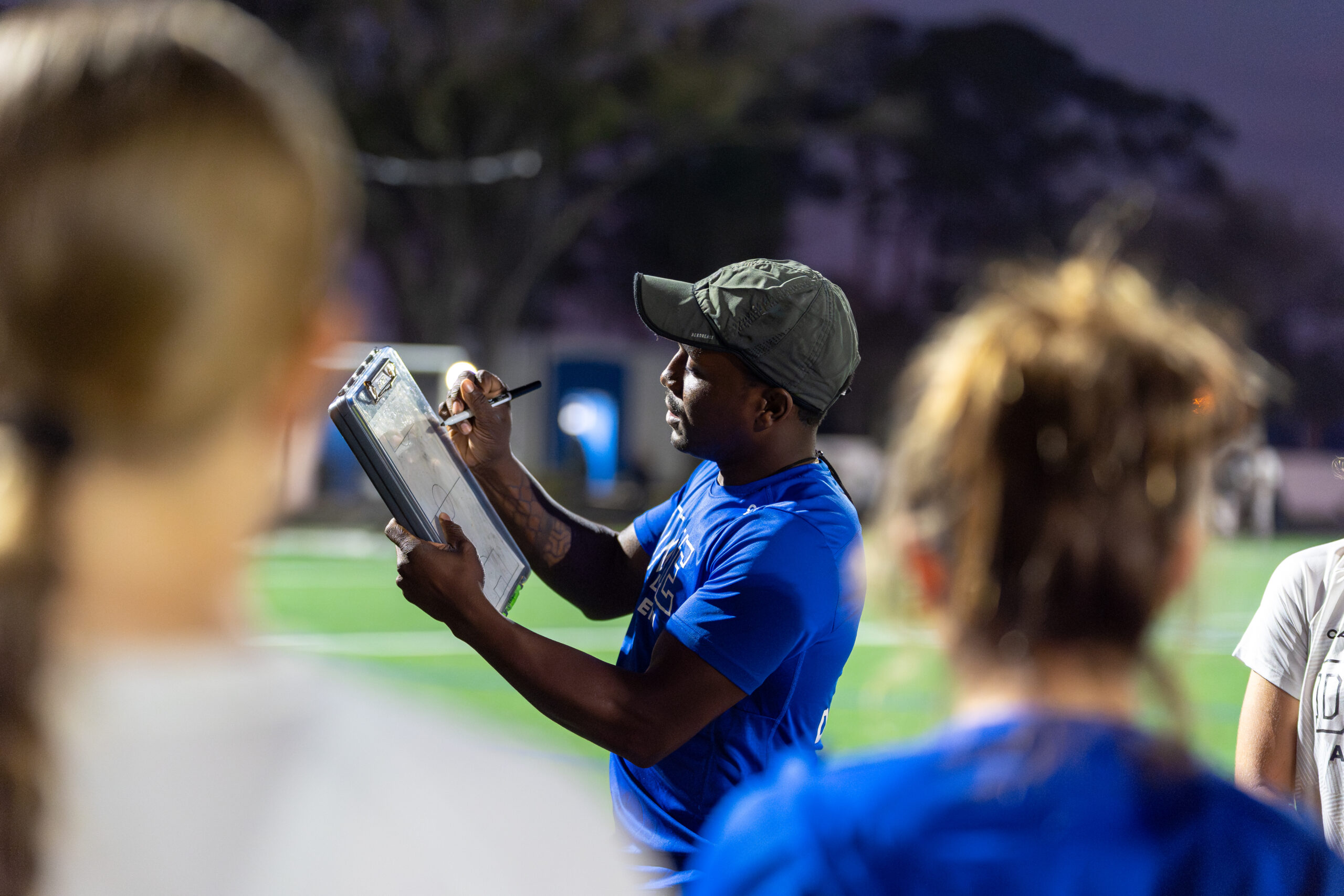 Coach Kioki Hutchings leading DME Academy soccer training session