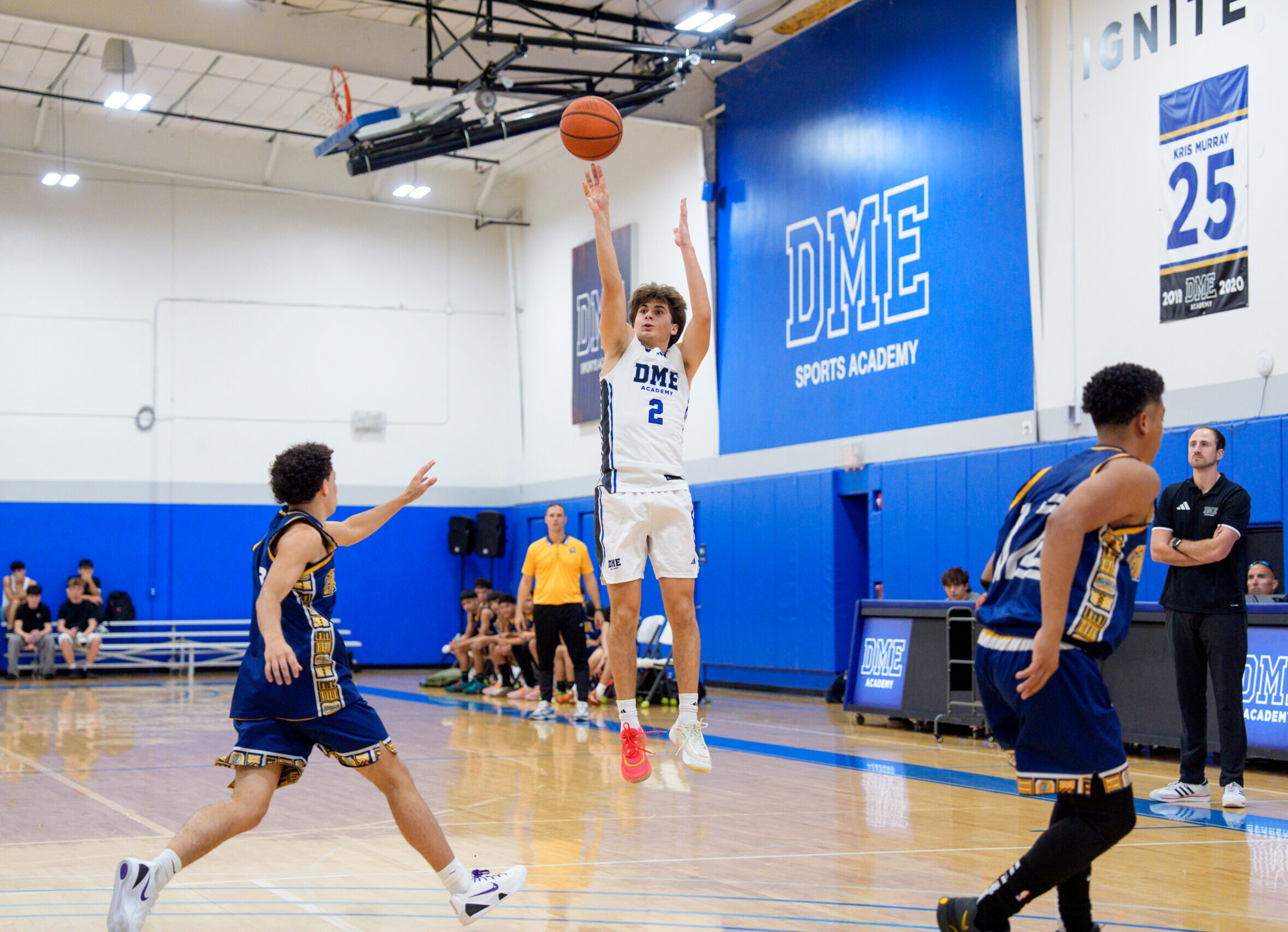 A player releases a jumper for the DME Blue Team