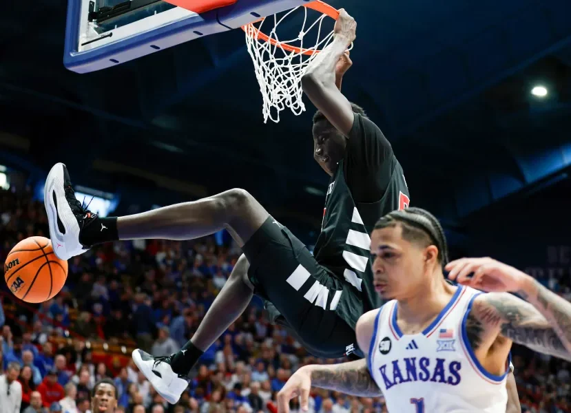 Thiam dunks in an upset over Kansas.