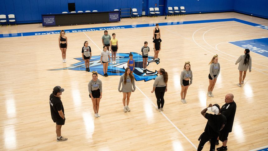 A wide view of the DME cheer floor during a full-squad session.