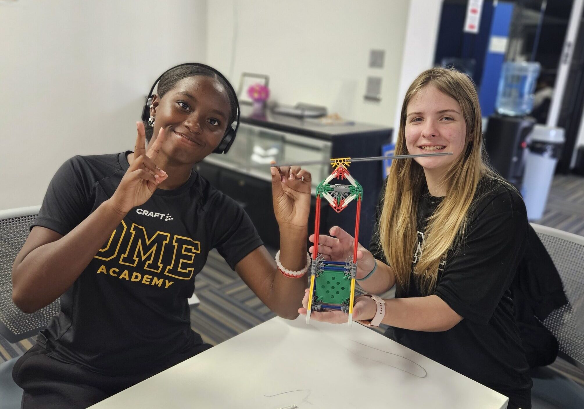 Two students show off their work