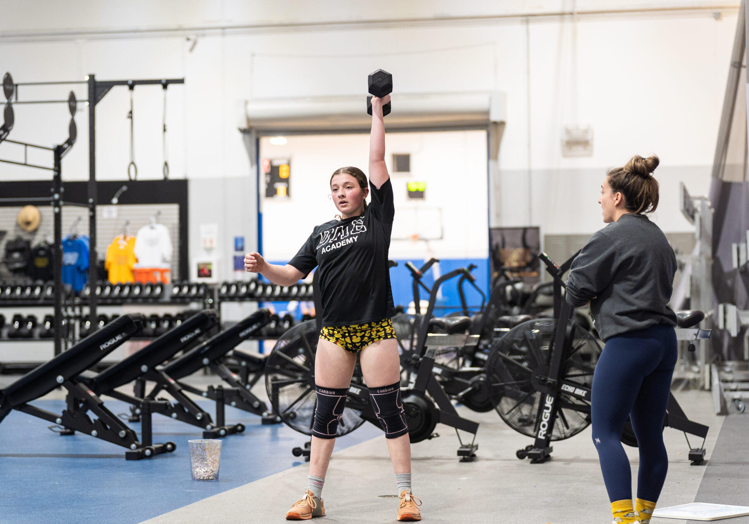 Samantha Reagan competing in the 2025 CrossFit Open, showcasing strength and determination as she lifts weights during a high-intensity workout.