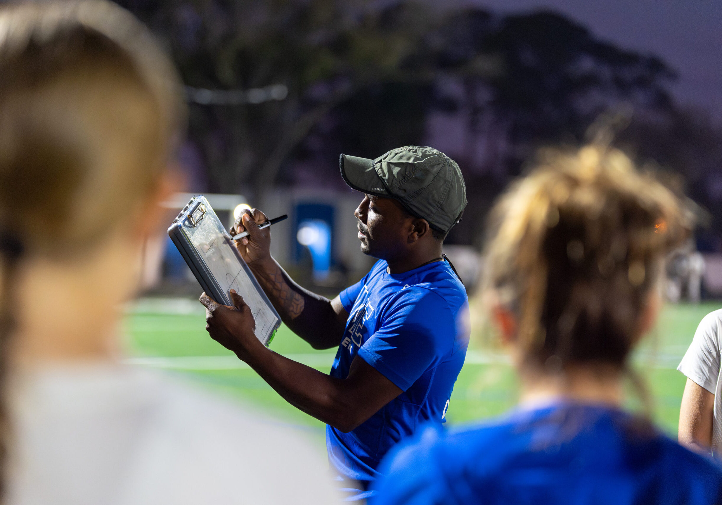 Coach Kioki Hutchings leading DME Academy soccer training session